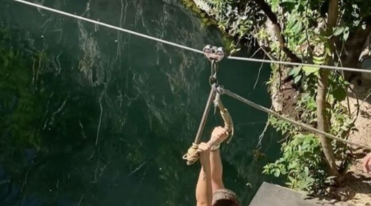 In the video Mulatto is seen naked zip lining into a lake of water, then sw...